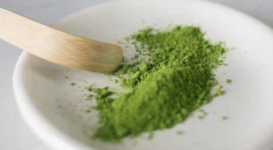 Matcha powder on a dish with bamboo spoon